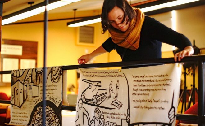 Photo of Michelle Sayles installing the Najawa comic at VT Law School.