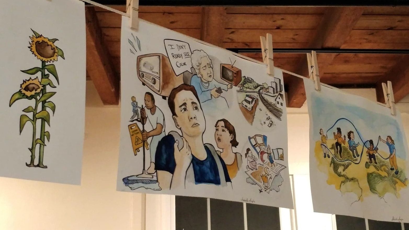 Drawings hanging from clothesline